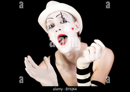 Funny screaming mime in white hat isolated on black background Stock Photo