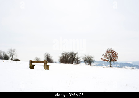 Snow covered bench and view at Rudge Hill near Stroud, Gloucestershire, England, United Kingdom Stock Photo