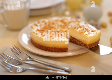 A Cheesecake with a portion being taken out. Stock Photo