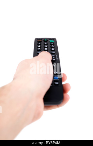 Hand holding television remote Isolated over white background . Stock Photo