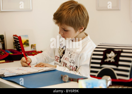 Boy (6 years) doing homework Stock Photo