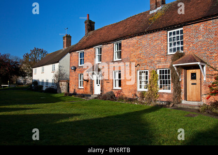 A row of red brick Georgian terraced cottages in the village of Aldbourne, Wiltshire, England, UK Stock Photo