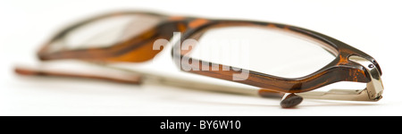 Pair of reading glasses on white