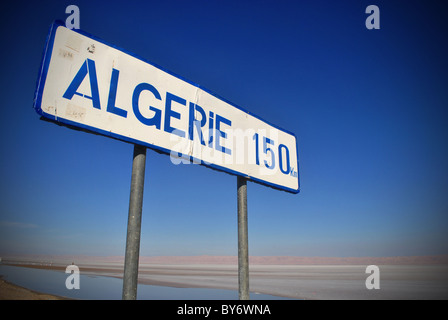 A roadsign on the way to Algeria near Tozeur, Tunisia Stock Photo