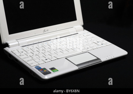 White Asus Eeepc 10 inch screen windows netbook mini laptop computer PC isolated on black Stock Photo