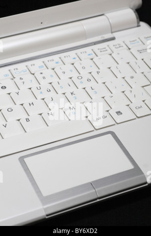 White Asus Eeepc 10 inch screen windows netbook mini laptop computer PC isolated on black Stock Photo