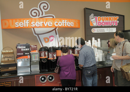 Fort Ft. Lauderdale Florida,FLL,Fort Lauderdale Hollywood International Airport,fast food,snack,Dunkin' Donuts,sign,self serve coffee,man men male,wom Stock Photo