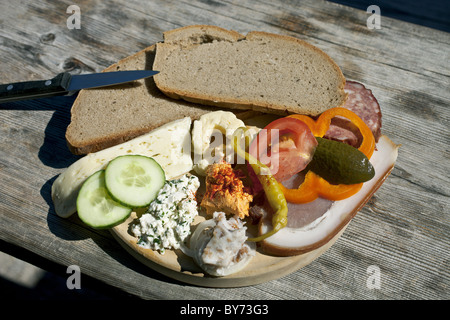 Typical snack of assorted cheese, ham, salami and bread, Loosegg Alm, Salzburger Land, Austria Stock Photo