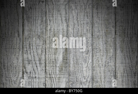 Weathered gray wooden barn siding using vertical planks lit dramatically from above Stock Photo