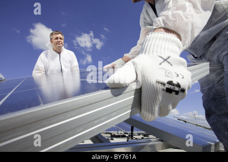 Technicians installing a photovoltaic power plant, Hamburg, Germany Stock Photo