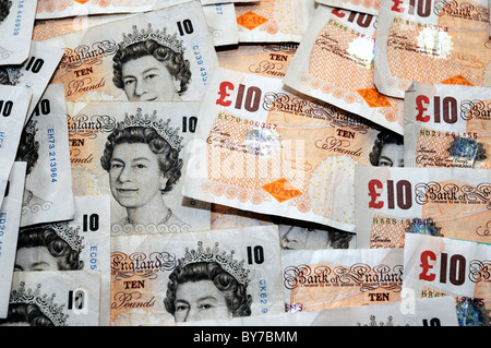 Stacks of ten 10 pound notes Sterling on a white background ...