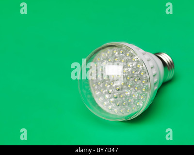 LED light bulb. Energy saving light source. Isolated on green background. Stock Photo