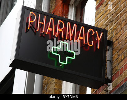 A neon pharmacy sign in a U.K. city. Stock Photo