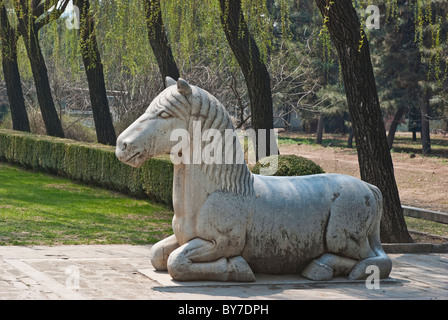 Asia, China, Beijing, Changping. Oversize sculpture of sitting horse; one of 36 figures on the Sacred Way at Ming Tombs. Stock Photo