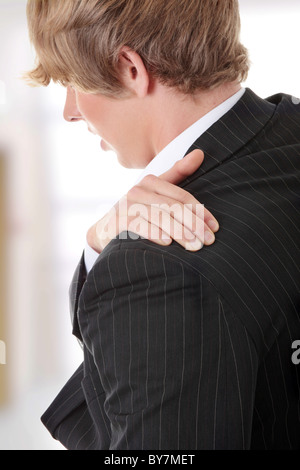 Businessman holding his hand to his aching back Stock Photo