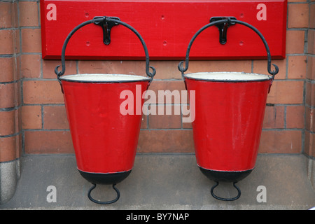 two vintage red metal fire buckets great central railway loughborough Stock Photo