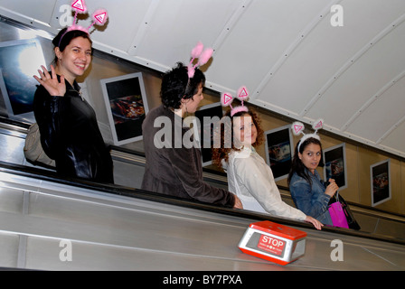 GROUP OF WOMEN ON HEN NIGHT TRAVELING ON TUBE WITH SILLY HEADBANDS Stock Photo