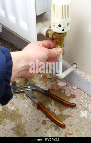 DIY plumber repairing a leaky radiator pipe, UK Stock Photo - Alamy