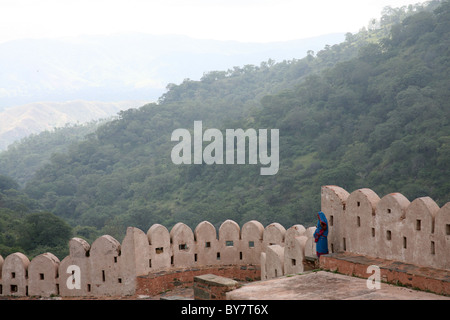 View of ramparts and beyond with solitary figure at Kumbalgarh Fort near Udaipur, Rajasthan, India Stock Photo