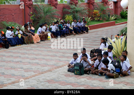 rural indian school kids sitting infront of a water theme park for study tour,kanyakumari,tamilnadu,india Stock Photo