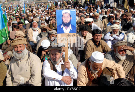 Supporters of Jamat-e-Islami listen speech of JI Ameer, Syed Munawar Hassan during sit-in in favor of their demands Stock Photo