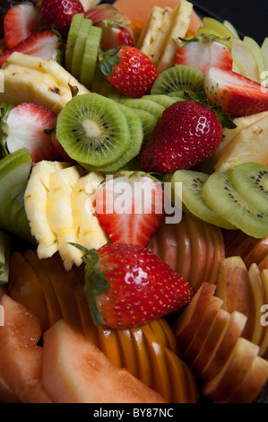 Freshly cut fruit salad with kiwi, pineapple, strawberries and melon Stock Photo