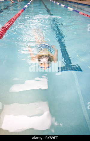 swimmer swimming laps in gym pool. Stock Photo