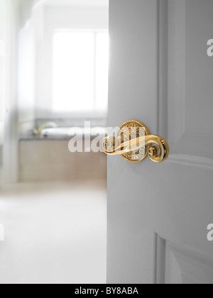 Door With Fancy Knob Partially Open With Bright White Bath Room Stock Photo