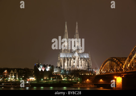 Cologne cathedral with Hohenzollern bridge at night Stock Photo