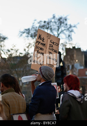 Student protestor with a placard in Parliament Square during student fees protest in London 9/12/2010 Stock Photo