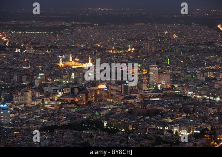 View over Damascus at night with the illuminated Great Umayyad Mosque in the background.  Taken from Jebel Quassioun Stock Photo