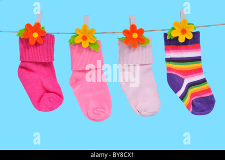 Four Colorful Socks Drying on a String Stock Photo