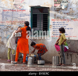 India, Uttar Pradesh, Agra, Teenage girls collecting water from village pump Stock Photo