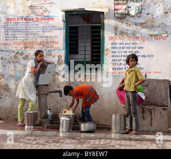 India, uttar Pradesh, Agra, teenage girls collecting water from village pump Stock Photo