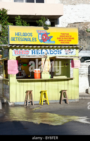 brightly painted wooden stall selling artisanal ice cream & other treats on main street of Puerto Angel Oaxaca State Mexico Stock Photo