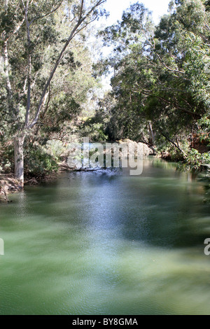 The calm waters of the Jordan River flow south toward the Dead Sea in the land of Galilee, Israel. Stock Photo