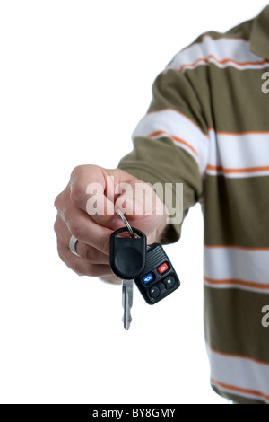 Man's hand holds out key to the family car as if handing them to someone. Stock Photo