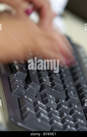 Two hands typing on a computer keyboard Stock Photo