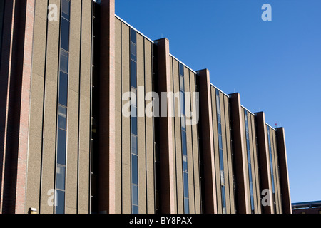 A modern hospital building is shown against a blue sky. Stock Photo