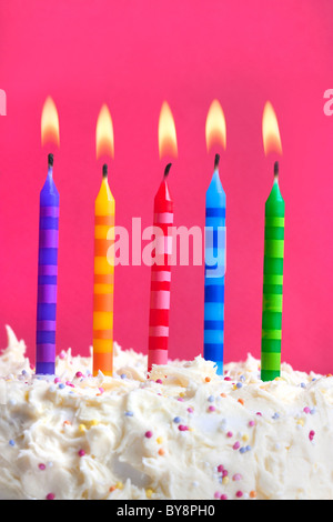 Close up macro photograph of 5 candles on a birthday cake Stock Photo