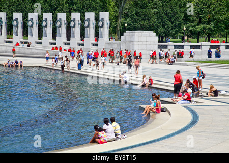 Visitors are cooling their feet in the pool at the World War II Memorial, Washington;DC; Ameria Stock Photo