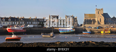 The Eglise Saint-Nicolas / Church of Saint Nicolas and fishing boats at the port of Barfleur, Normandy, France Stock Photo