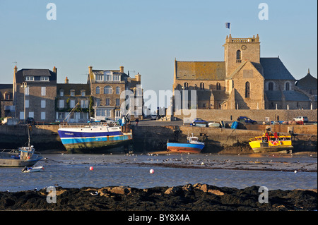 The Eglise Saint-Nicolas / Church of Saint Nicolas and fishing boats at the port of Barfleur, Normandy, France Stock Photo