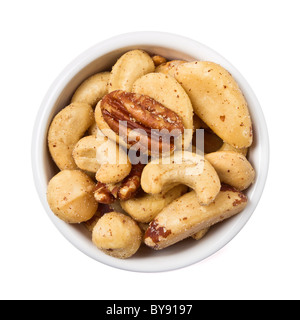 Mixed Salted Nuts in bowl overhead view isolated on white. Stock Photo