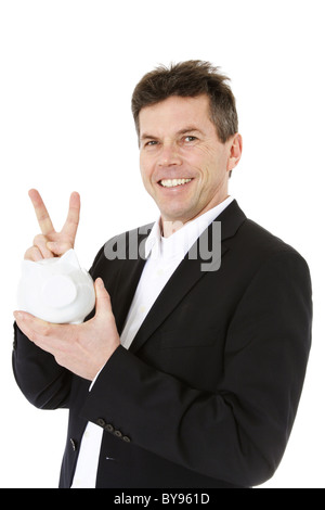 Attractive middle-aged man holding piggy bank. All on white background. Stock Photo