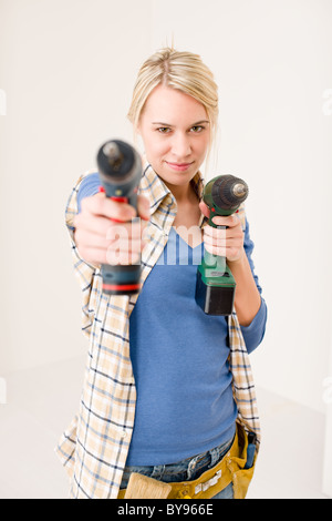 Home improvement - woman with battery cordless screwdriver Stock Photo