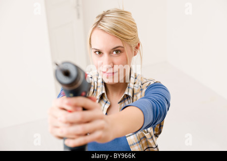 Home improvement - woman with battery cordless screwdriver Stock Photo