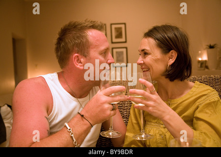 Couple toasting one another Stock Photo