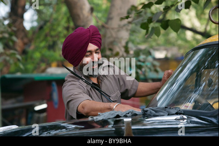 Sikh taxi driver cleaning his vehicle Stock Photo
