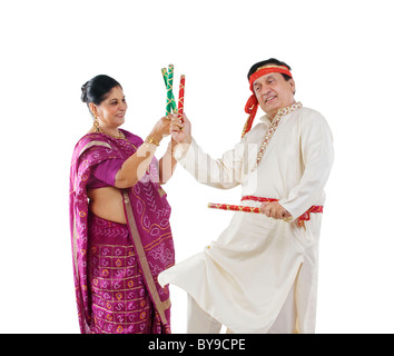 Couple performing dandiya dance Stock Photo